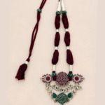 Handcrafted Saanvi statement neckpiece with burgundy threads, green stones, ruby-red detailing and silver-toned Indian jewellery accents