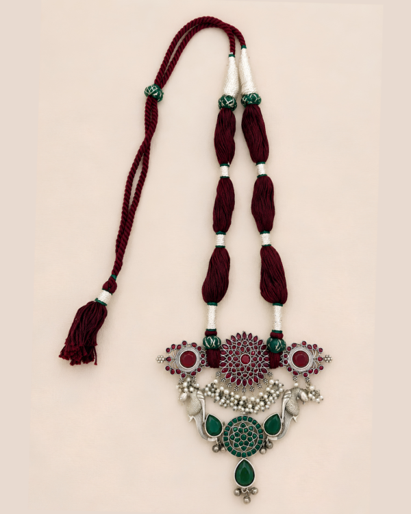 Handcrafted Saanvi statement neckpiece with burgundy threads, green stones, ruby-red detailing and silver-toned Indian jewellery accents