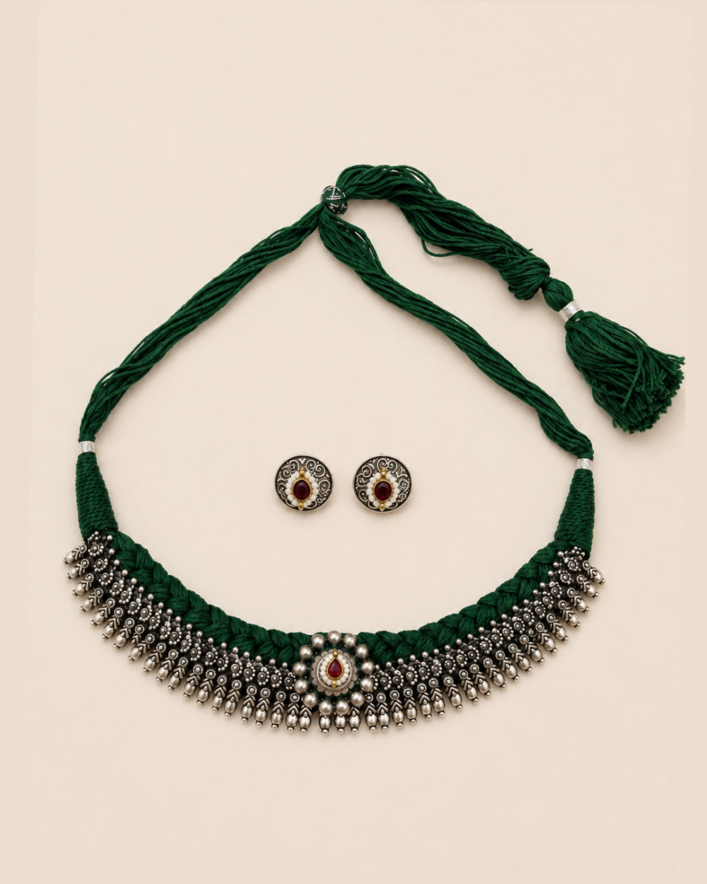 Jashn handcrafted green thread choker with antique silver detailing and red stone