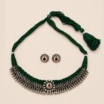 Jashn handcrafted green thread choker with antique silver detailing and red stone