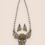 Aarambh (आरम्भ) heritage statement jewellery set featuring a green stone statement neckpiece and matching statement earrings by House of Evia.
