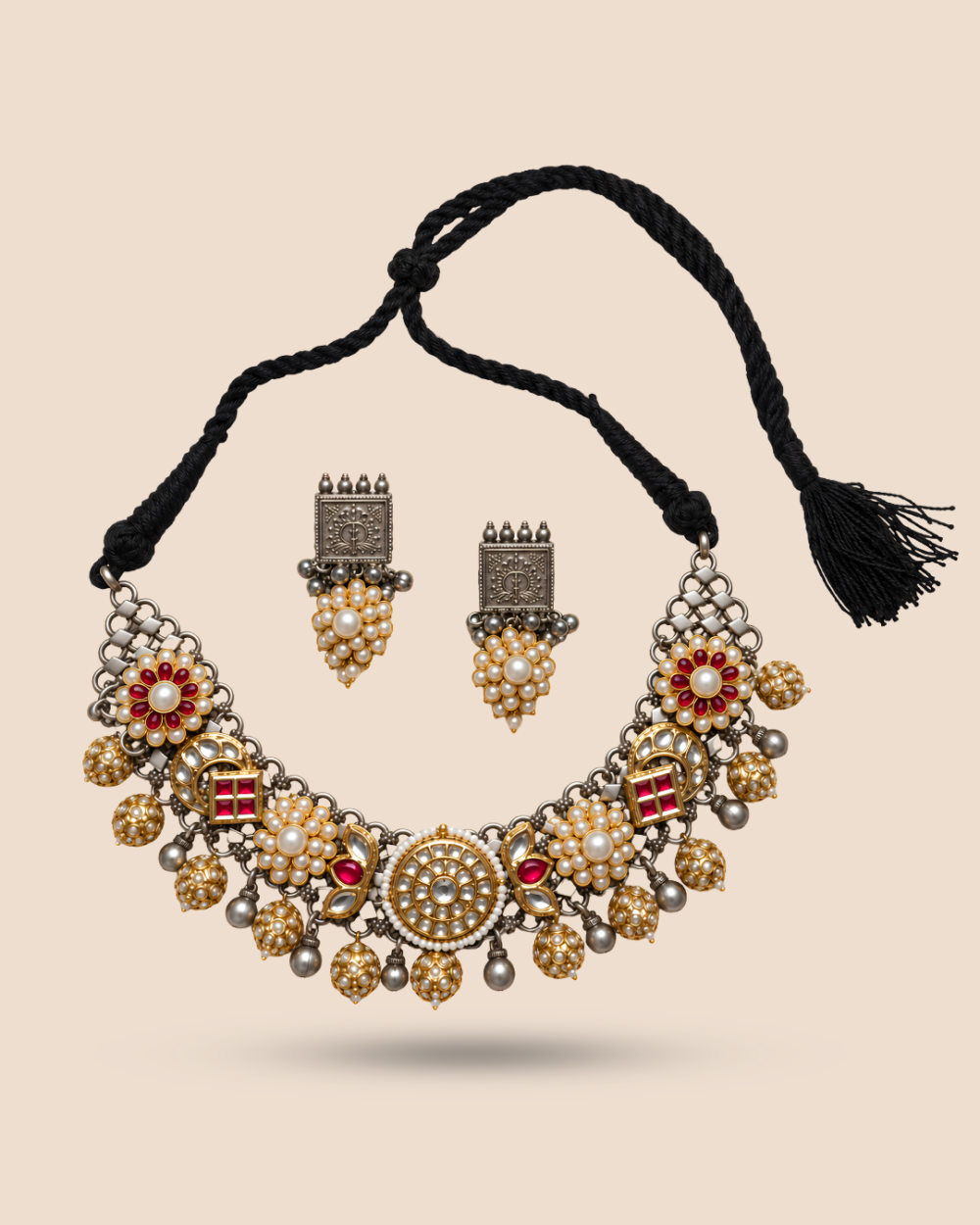 Two-tone silver and gold choker with kundan, pearl and red stone florals on an adjustable black tassel cord, with matching pearl drop earrings