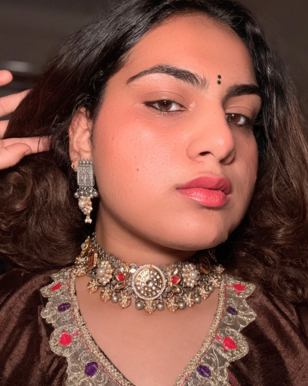 Two-tone silver and gold choker with kundan, pearl and red stone florals on an adjustable black tassel cord, with matching pearl drop earrings