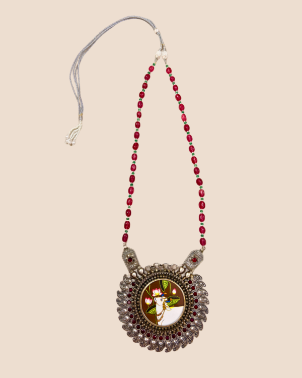 Aabha oxidised silver neckpiece with Pichwai cow painting pendant, paisley fringe and ruby-pink bead strand