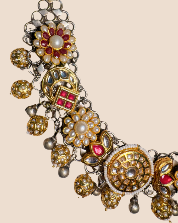 Two-tone silver and gold choker with kundan, pearl and red stone florals on an adjustable black tassel cord, with matching pearl drop earrings